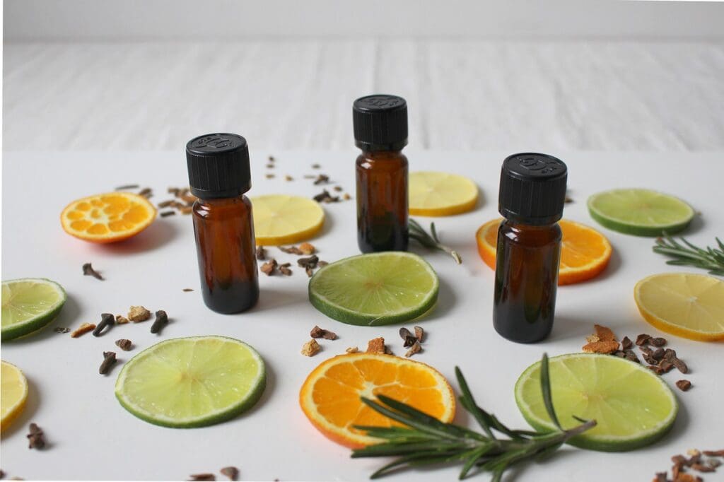 bottles of essential oils with slices of citrus fruits